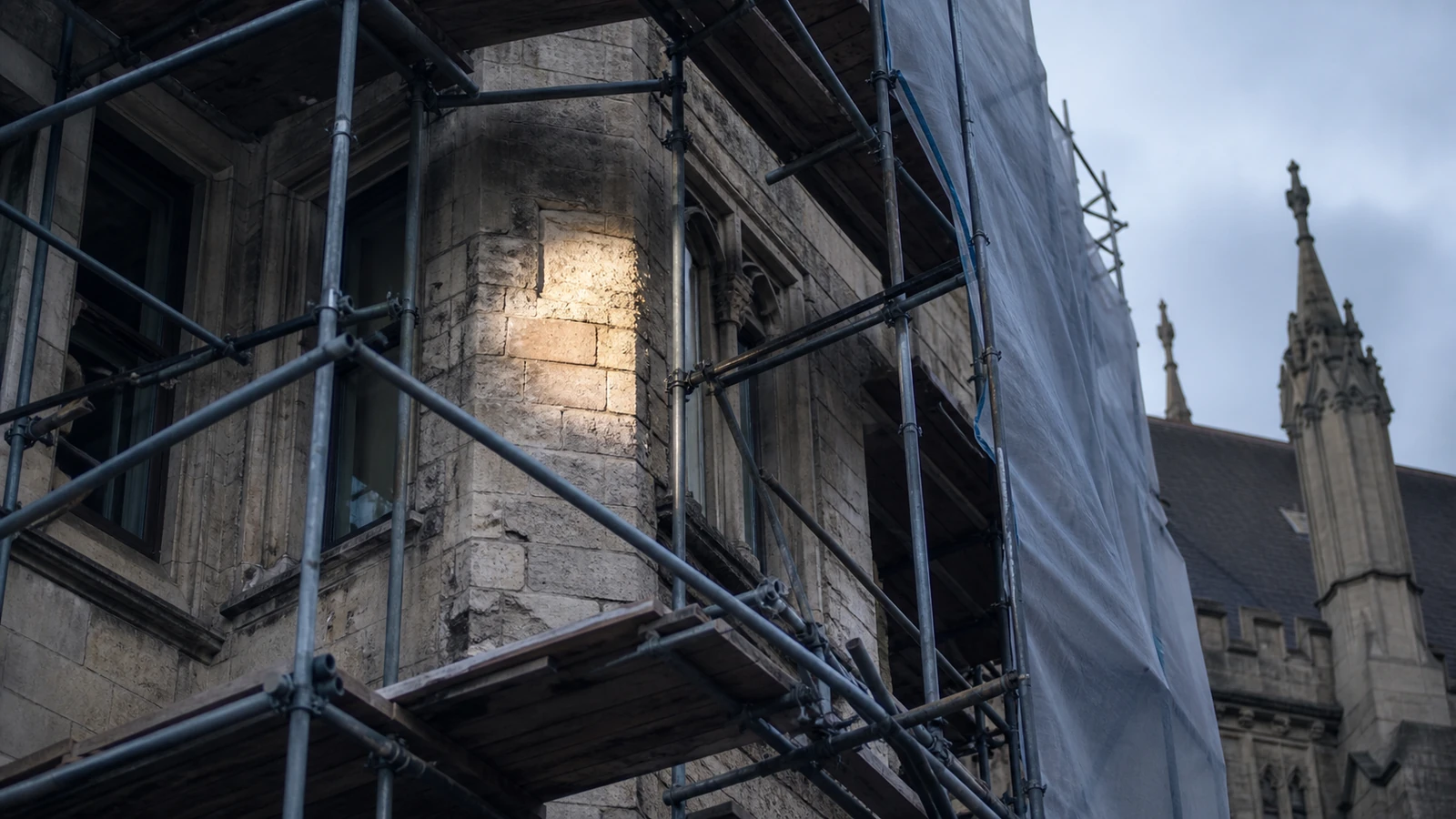 Scaffolding against a period stone building during a summer refurbishment programme